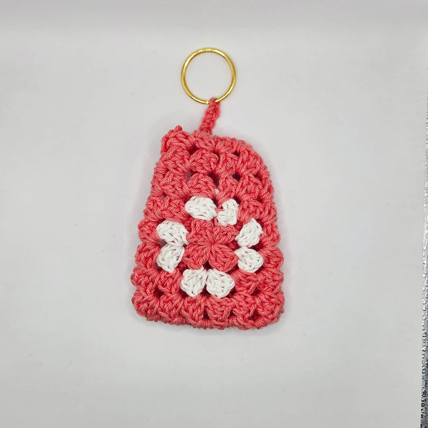 Handmade pink and white crochet keychain with floral design by Erika Liesel