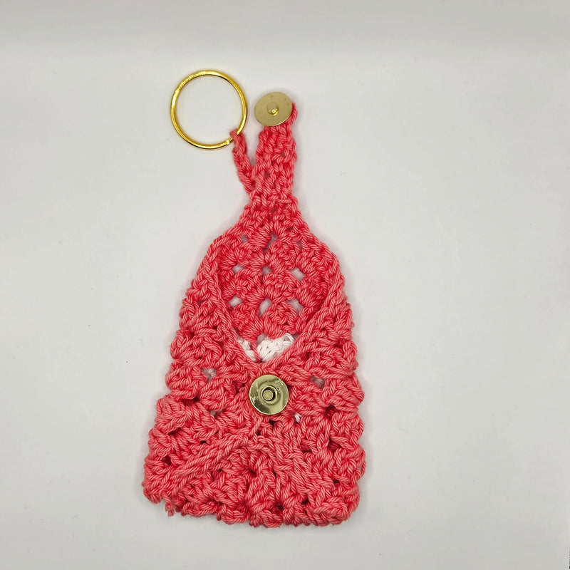 Handmade pink crochet keychain pouch with gold ring and button, cozy gift by Erika Liesel