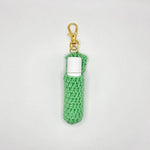 Handmade green crochet lip balm holder with gold clip, cozy and portable