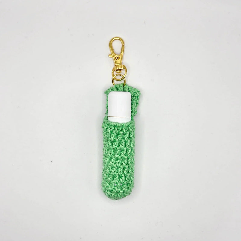 Mint green crochet chapstick holder with gold clasp, handmade by Erika Liesel