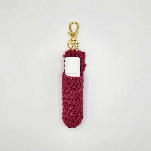 Handmade crochet lip balm holder in red yarn with gold clasp by Erika Liesel