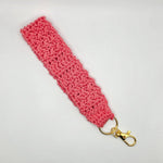 Handmade pink crochet keychain with gold clasp, cozy and creative accessory