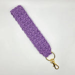 Handmade purple crochet keychain with gold clasp, cozy and creative accessory