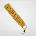 Handmade mustard yellow crochet keychain with gold clasp, cozy and creative accessory