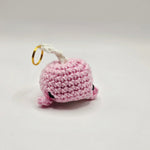 Pink crochet whale keychain with gold ring, handmade amigurumi charm for bags or keys