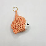 Handmade crochet fox keychain with orange and white yarn, perfect cozy gift