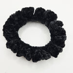 Black crochet scrunchie with textured, fluffy design for cozy hair styling