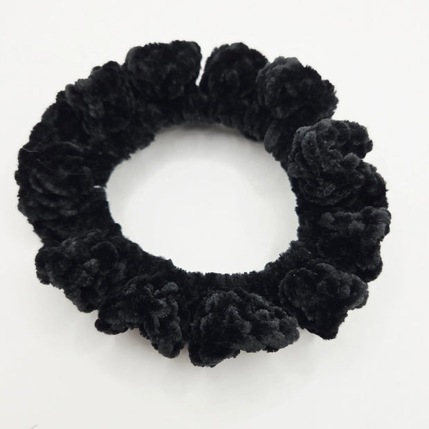 Handmade black crochet scrunchie on white background, cozy accessory by Erika Liesel