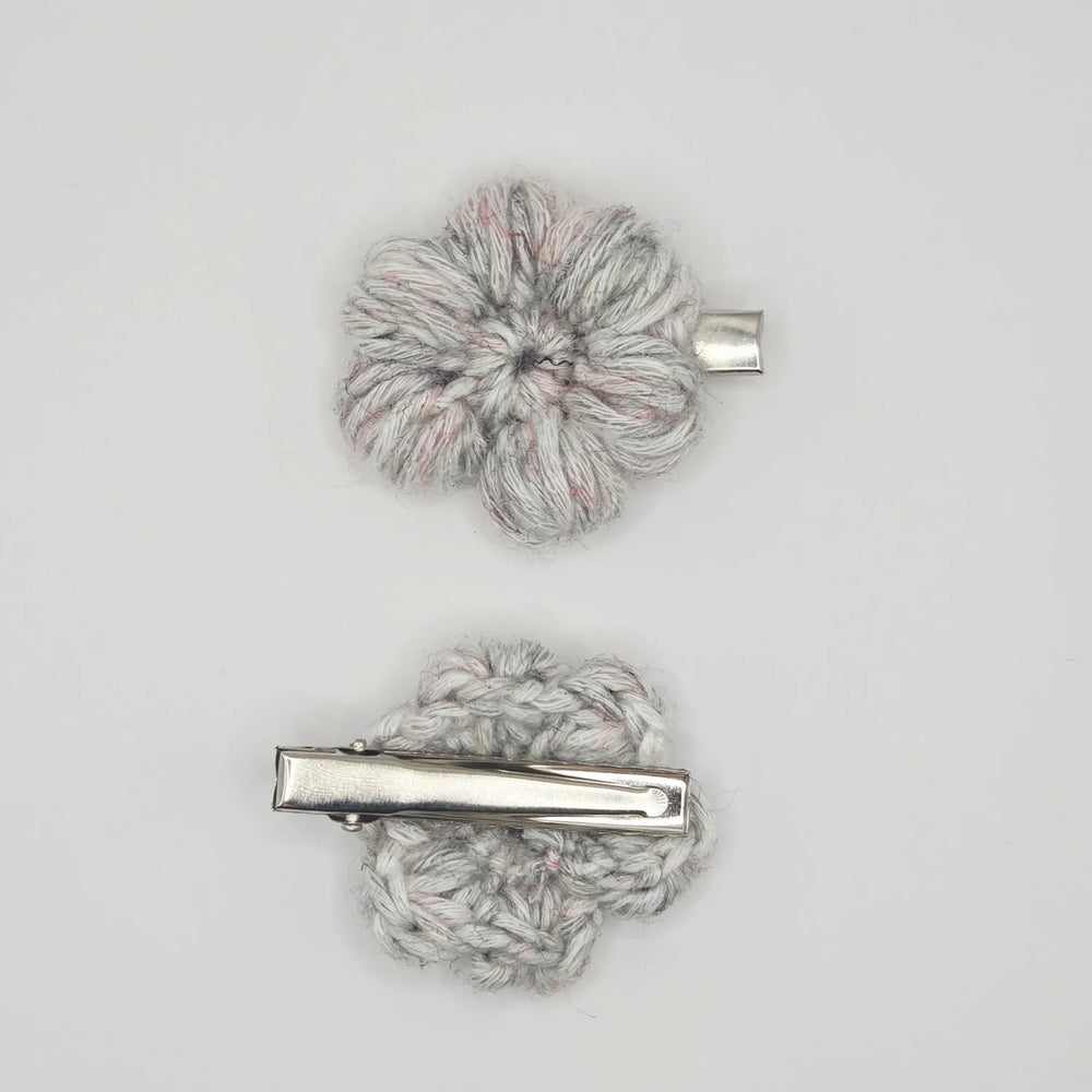 Handmade crochet flower hair clips in soft gray with pink accents, cozy and creative accessory