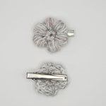 Handmade crochet flower hair clips in soft gray with pink accents, cozy and creative accessory