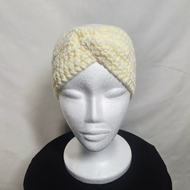 Handmade crochet cream headband on mannequin, cozy accessory by Erika Liesel