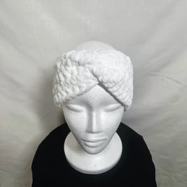Handmade white crochet headband displayed on a mannequin, cozy winter accessory