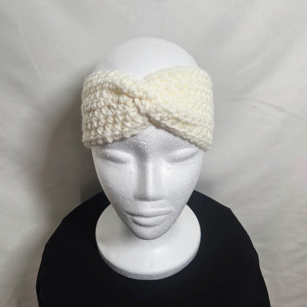Handmade crochet white headband on mannequin, cozy winter accessory by Erika Liesel