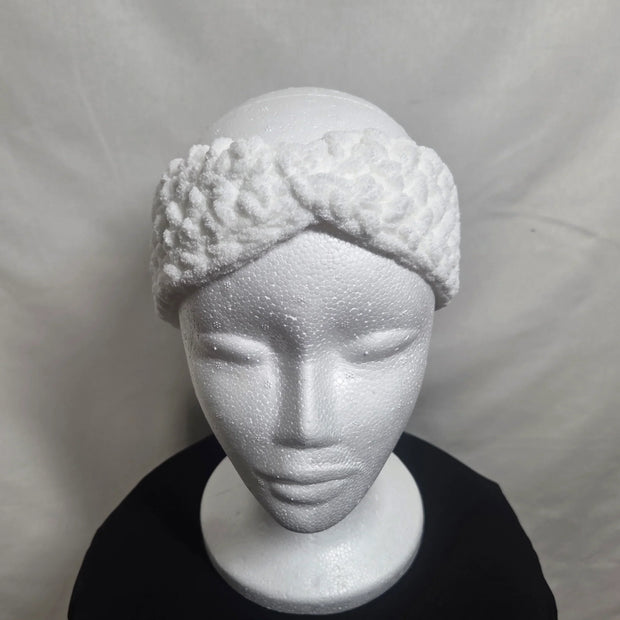 Handmade white crochet headband on mannequin, cozy winter accessory by Erika Liesel