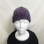 Handmade crochet beanie in purple and pink variegated yarn, cozy winter hat on mannequin