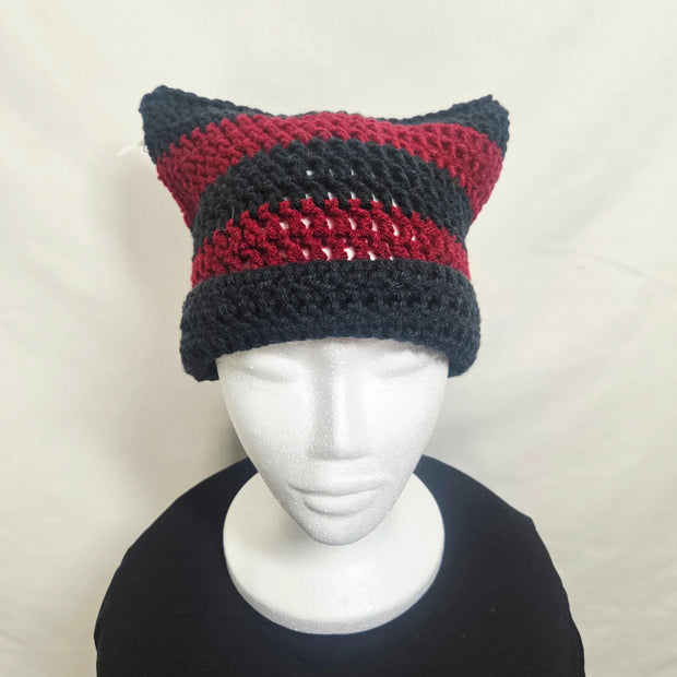 Handmade crochet cat ear beanie in black and red stripes on mannequin, cozy knit gift