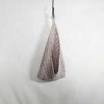 Handmade crochet hanging basket in soft gray, perfect for cozy home decor or gifting