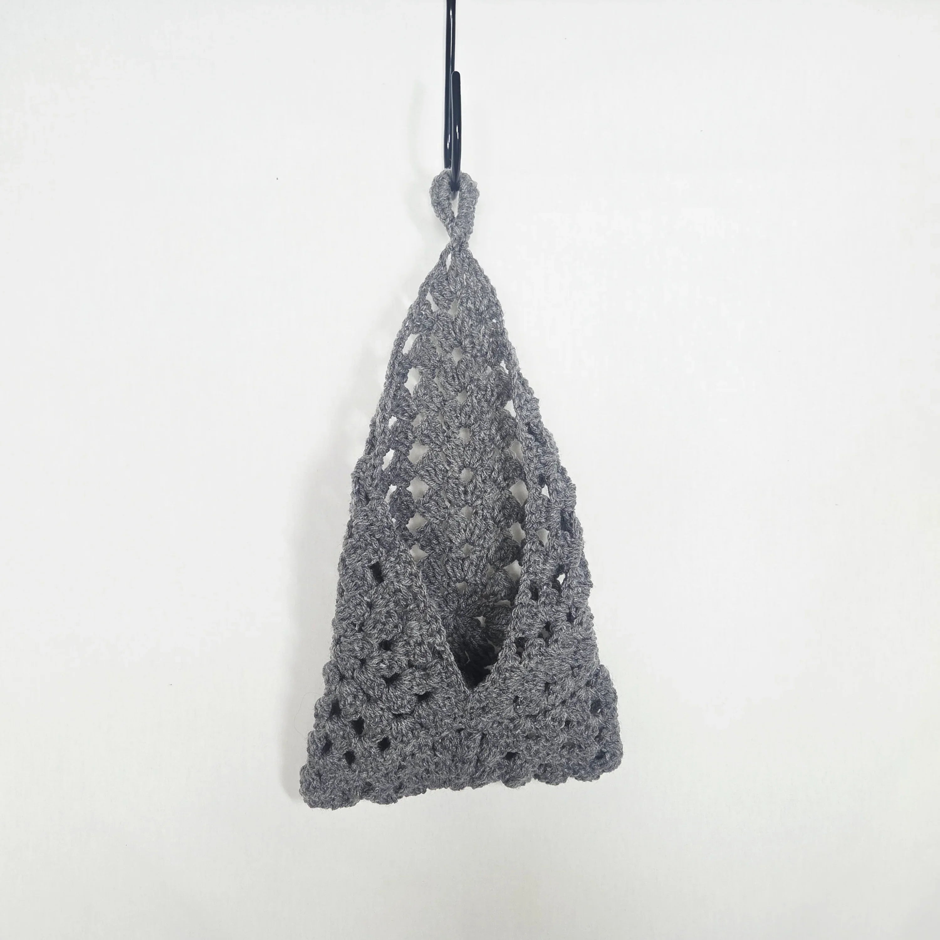 Handmade grey crochet hanging pouch against a plain white background
