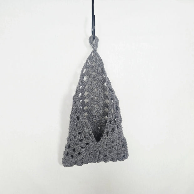 Handmade grey crochet hanging pouch against a plain white background