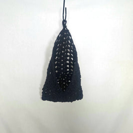 Handmade black crochet bag hanging on white background, cozy gift by Erika Liesel