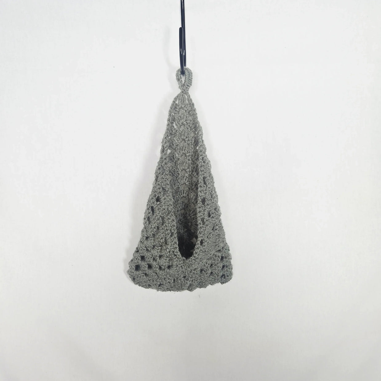 Handmade grey crochet hanging basket by Erika Liesel against a white background