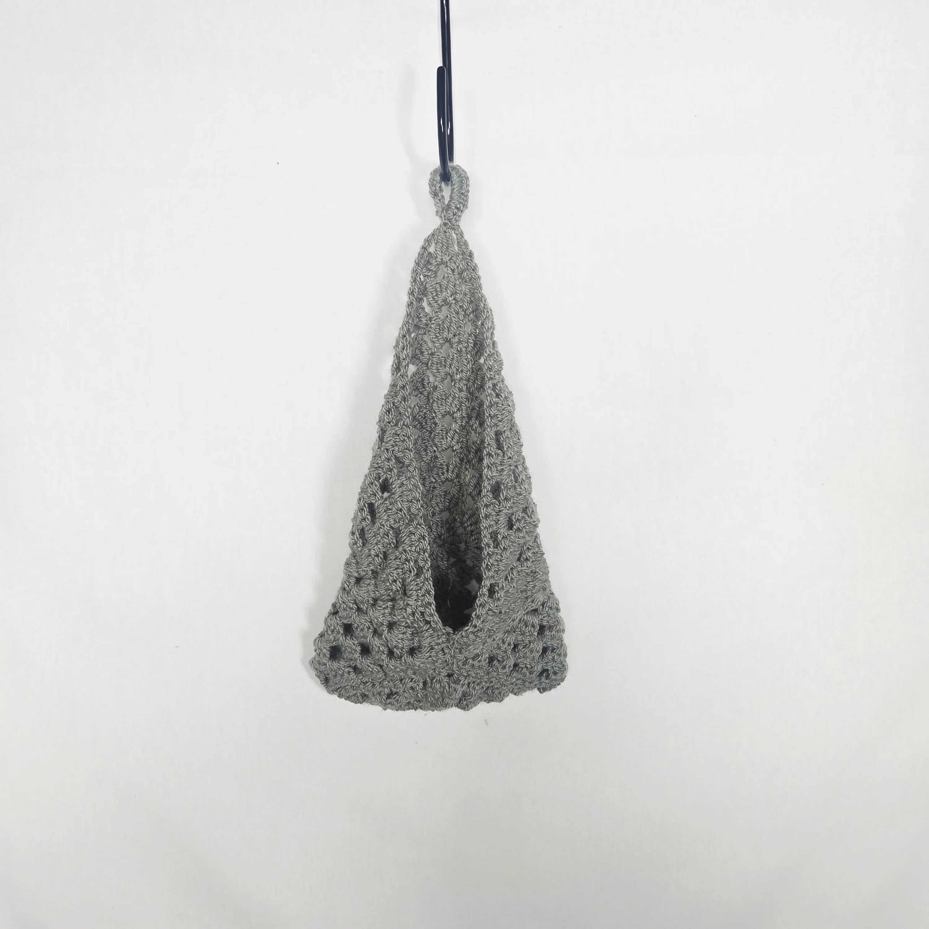 Handmade grey crochet hanging basket by Erika Liesel against a white background