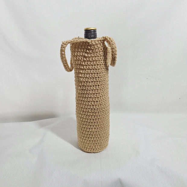 Handmade crochet wine bottle cover with handles on a white background