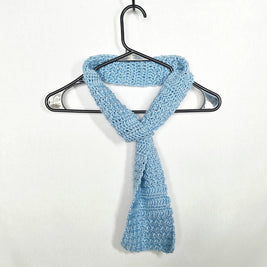 Handmade light blue crochet scarf on hanger, cozy gift by Erika Liesel
