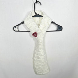 Handmade white crochet scarf with red rose accent on hanger, cozy gift by Erika Liesel