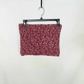 Handmade chunky crochet cowl scarf in maroon, displayed on a hanger against a white background.