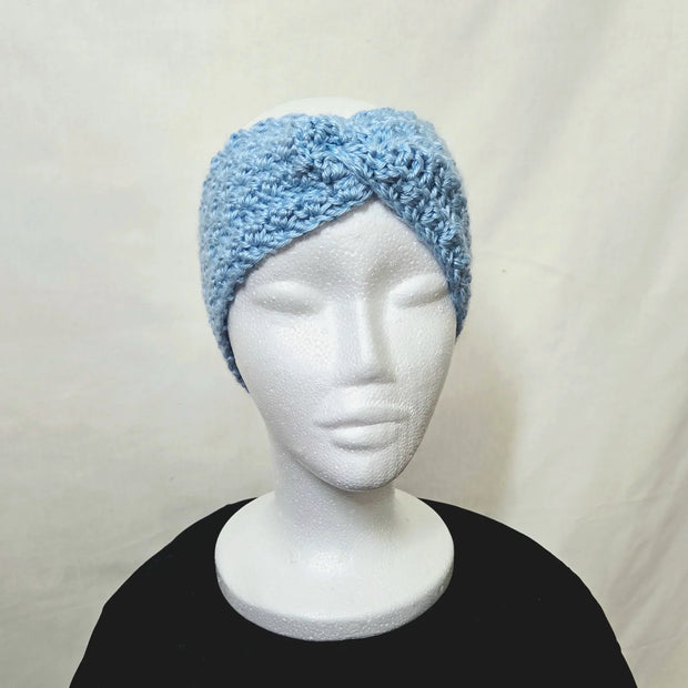 Handmade blue crochet headband displayed on mannequin, cozy accessory by Erika Liesel