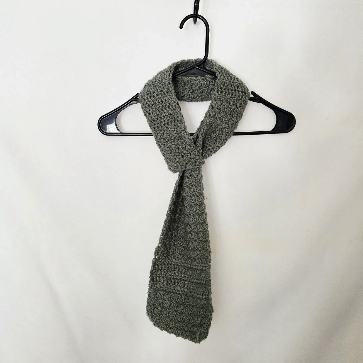 Handmade crochet scarf in grey yarn on hanger, cozy gift by Erika Liesel