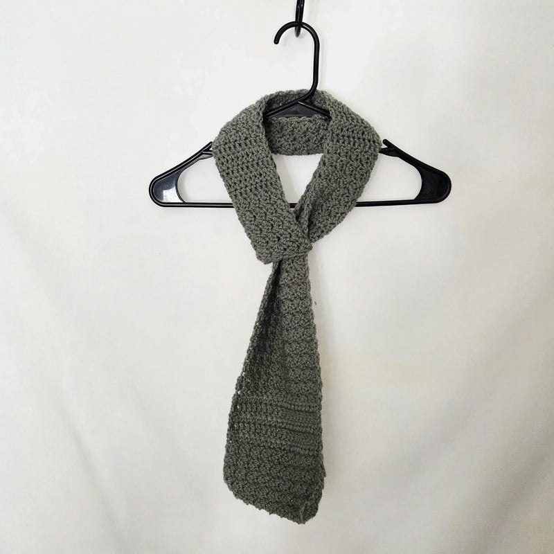 Handmade gray crochet scarf on black hanger, cozy winter accessory for gifts