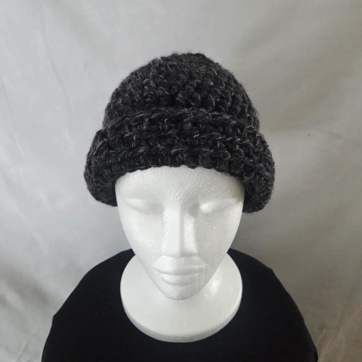 Handmade chunky dark gray crochet beanie hat on white mannequin, cozy winter gift