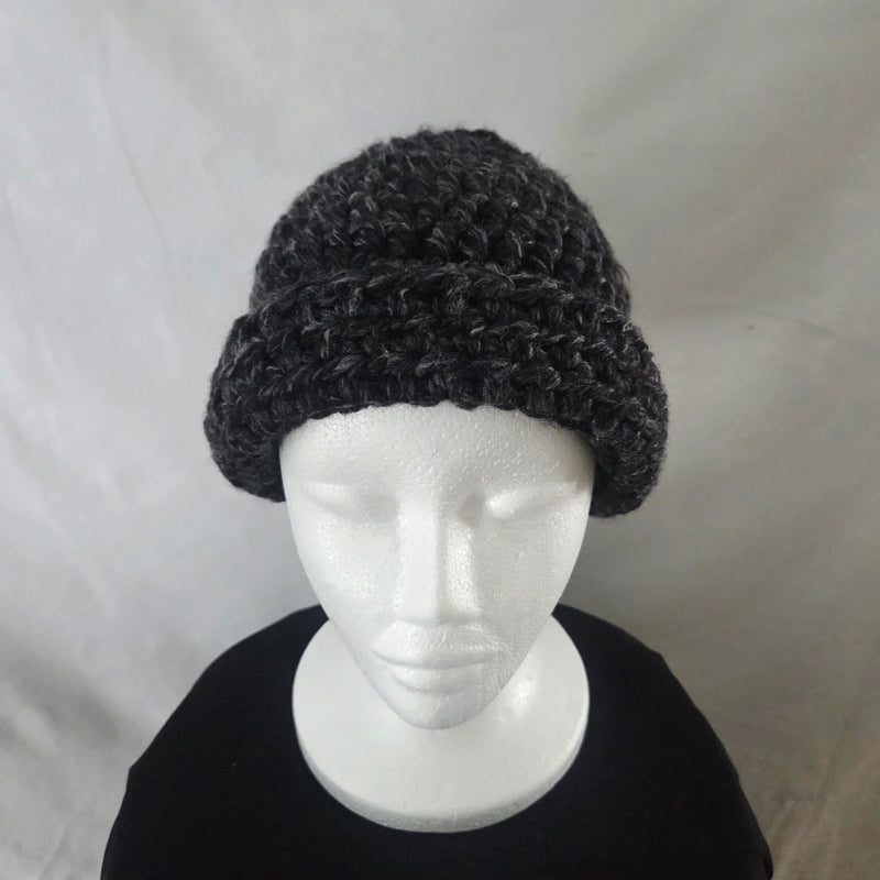 Handmade black crochet beanie hat on mannequin, cozy and stylish winter accessory
