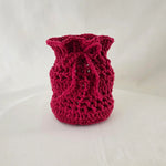 Handmade red crochet vase cover with textured pattern, cozy home decor accent