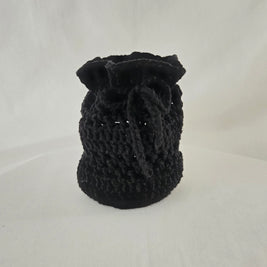 Handmade black crochet drawstring pouch on white background, cozy gift by Erika Liesel