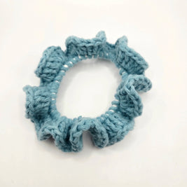 Handmade blue crochet scrunchie on white background, cozy accessory by Erika Liesel