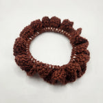 Handmade crochet hair scrunchie in rich brown, cozy and textured for everyday wear