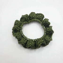 Handmade green crochet scrunchie on white background, cozy accessory by Erika Liesel