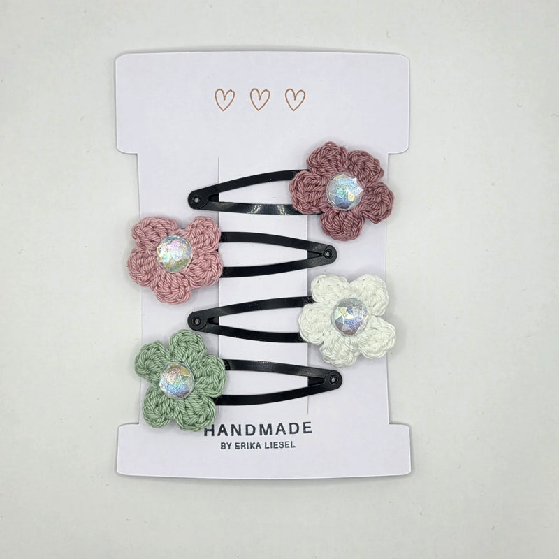 Handmade crochet flower hair clips with iridescent gems, soft pastel colors, perfect for cozy, creative styling.