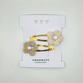 Handmade crochet flower hair clips with gold snap clips by Erika Liesel on display card