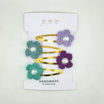 Handmade crochet flower hair clips with gold bars and crystal centers, perfect for cozy, creative styling.