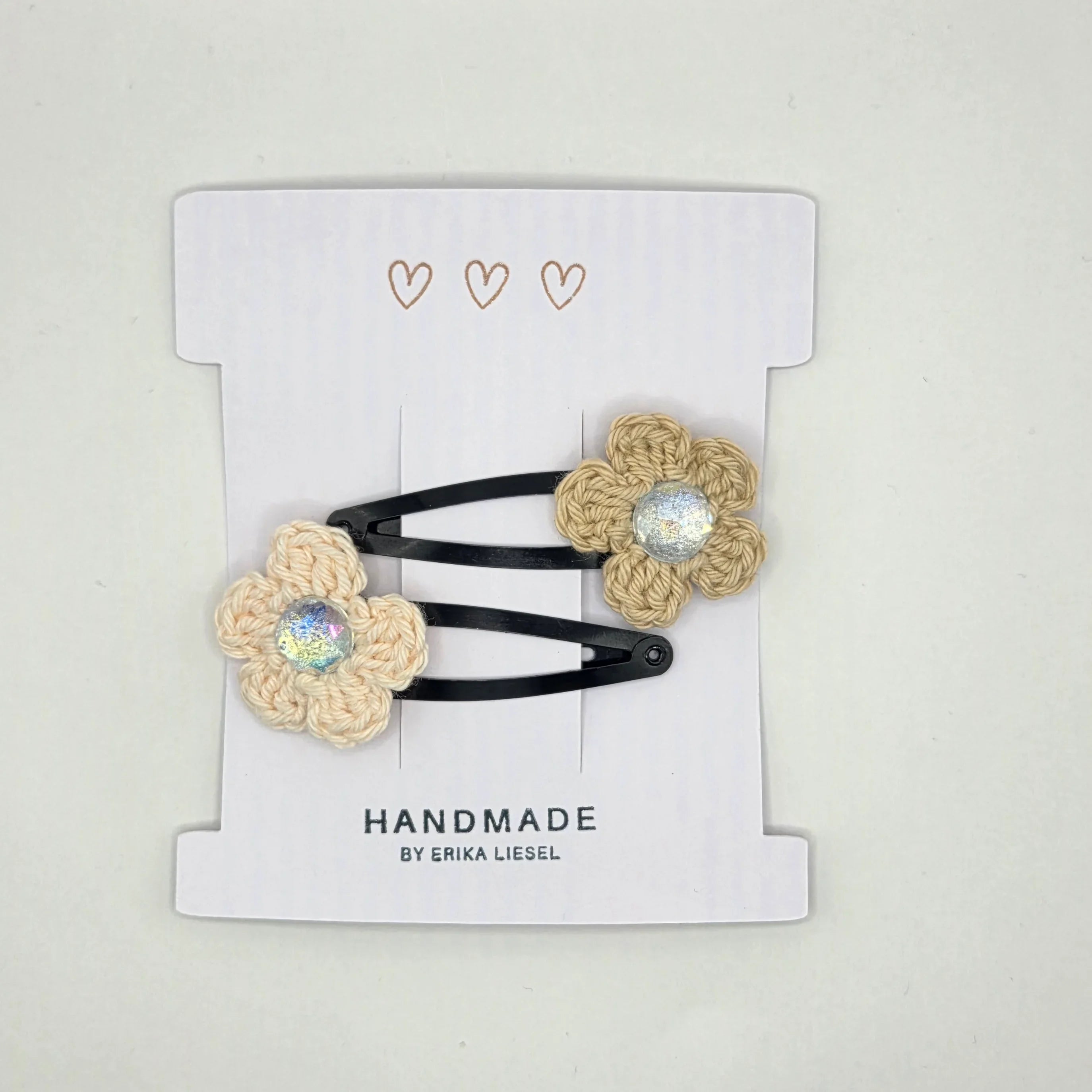 Handmade crochet flower hair clips with glitter center on a card by Erika Liesel