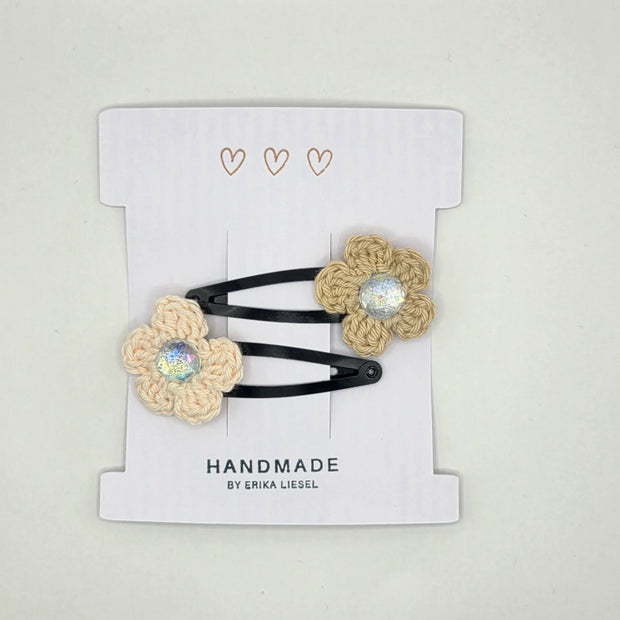 Handmade crochet flower hair clips with glitter center on a card by Erika Liesel