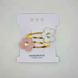 Handmade crochet flower hair clips with gems on a card labeled Erika Liesel