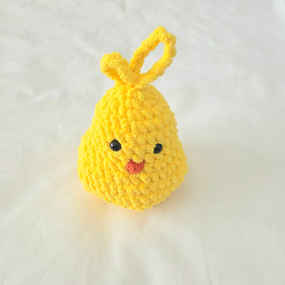 Handmade yellow crochet chick with black eyes and pink beak, perfect for Easter or baby gifts