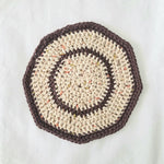 Handmade crochet coaster with cream and brown stripes, cozy textured design for home decor