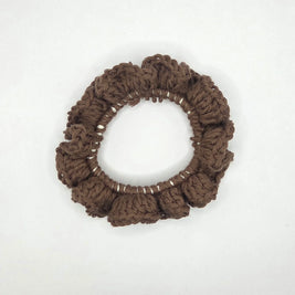 Handmade crochet brown hair scrunchie on white background, cozy gift by Erika Liesel