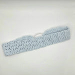 Light blue crocheted headband with metal ring, handmade for cozy comfort and style